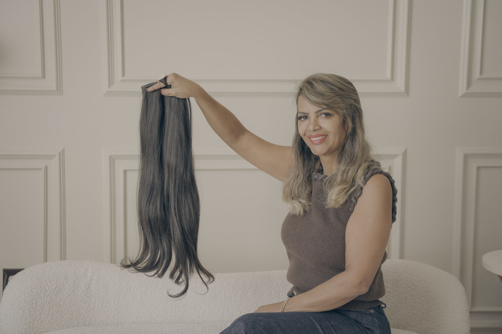 Claudia holding a premium hair extension